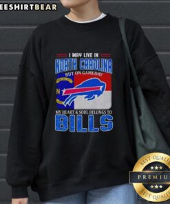 Cozy sweatshirt featuring 'I May Live In North Carolina But On Gameday My Heart Belongs To Bills' design, perfect for fans.