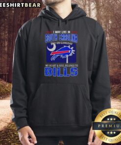 Top I May Live In South Carolina But On Gameday My Heart And Soul Belongs To Bills Hoodie worn by a fan at a game.