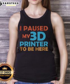 Top I Paused My 3D Printer To Be Here tank top displayed on a wooden background, perfect for 3D printing enthusiasts.