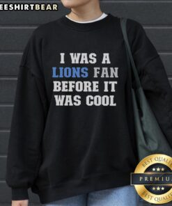 Cozy 'I Was A Lions Fan Before It Was Cool' sweatshirt featuring bold graphic design, perfect for Detroit Lions fans.