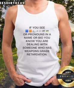 Person wearing a 'Flags' tank top with pronouns in their bio, showcasing LGBTQ+ pride and inclusivity.