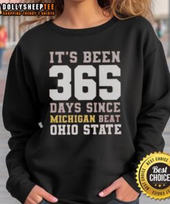 Michigan beat Ohio State sweatshirt celebrating 365 days of victory, featuring bold graphics and a cozy design.