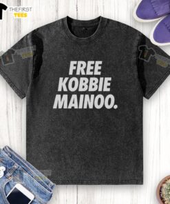 Alt Text: Top Man United Free Kobbie Mainoo washed t-shirt featuring bold graphics and comfortable fit for fans.