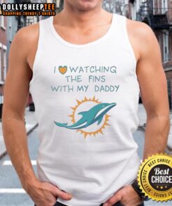 Child in a tank top enjoying a Miami Dolphins game with dad, showcasing love for the Fins and team spirit.