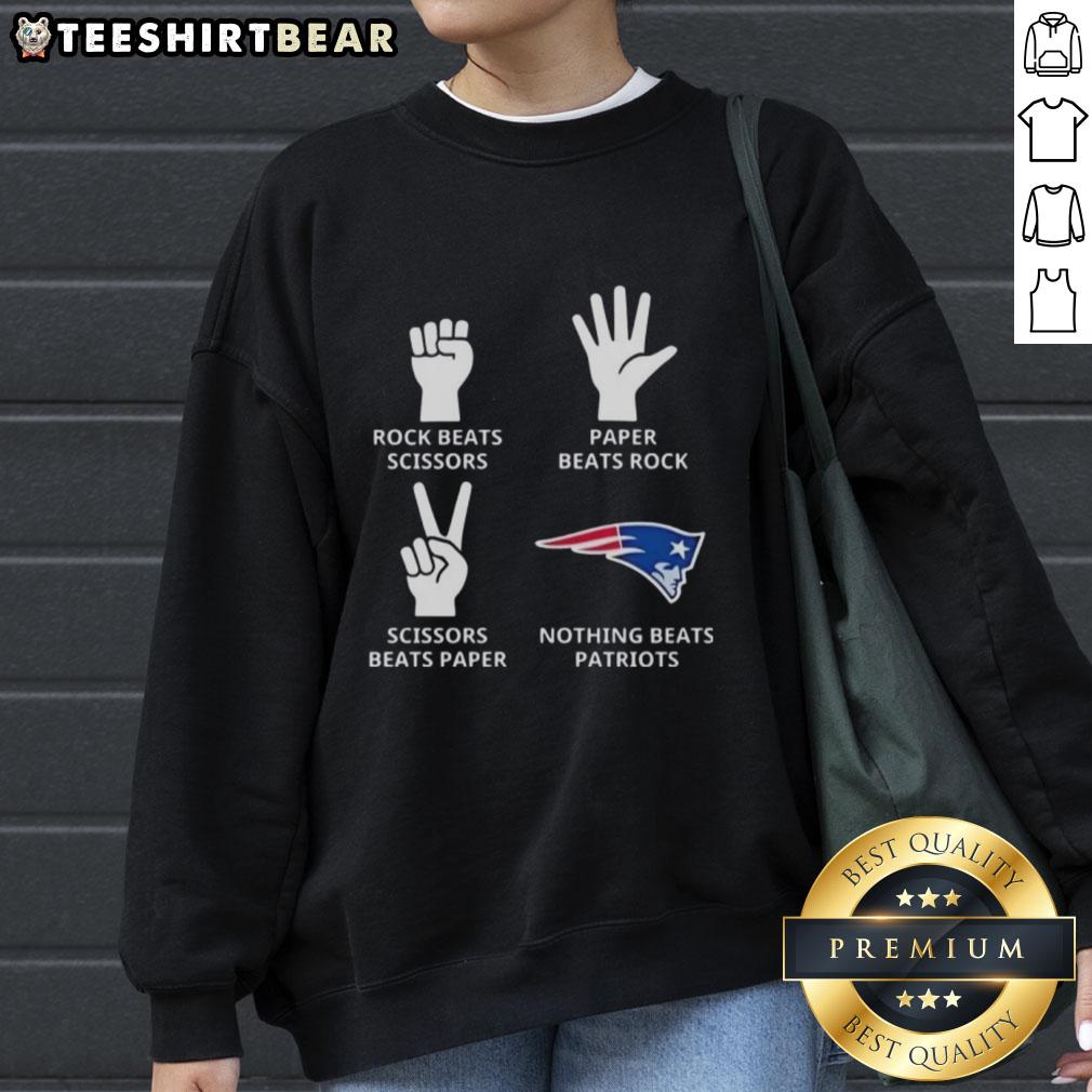 top-new-england-patriots-nothing-beats-rock-beats-scissors-paper-beats-rock-scissors-beats-paper-sweatshirt Alt Text: Top New England Patriots sweatshirt featuring a fun Rock, Paper, Scissors design for fans and gamers.
