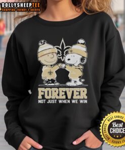 Top New Orleans Saints X Charlie Brown vs Snoopy sweatshirt showcasing fun design, perfect for fans and cozy wear.