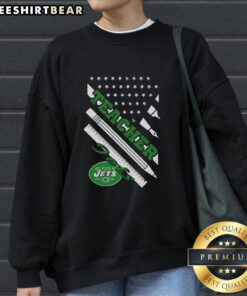 Alt Text: Cozy New York Jets football sweatshirt featuring a teacher theme and American flag design, perfect for fans.