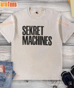 Top Sekret Machines washed t-shirt displayed on a wooden surface, featuring a vintage-style graphic and soft fabric.