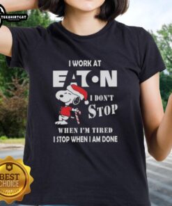Alt Text: Top Snoopy I Work At Eaton Corporation Christmas Ladies Tee with motivational quote and festive design.