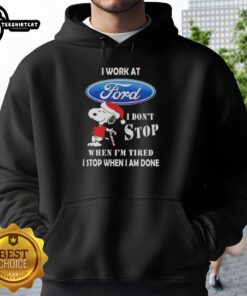 Snoopy Christmas hoodie with 'I work at Ford Motor, I don't stop when I'm tired, I stop when I'm done' design.