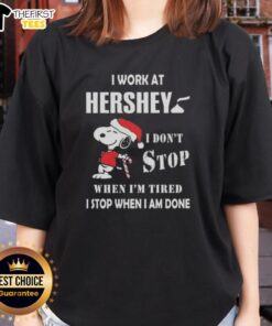Alt Text: Top Snoopy Christmas ladies tee featuring 'I work at Hershey, I don't stop when I'm tired, I stop when I'm done' quote.