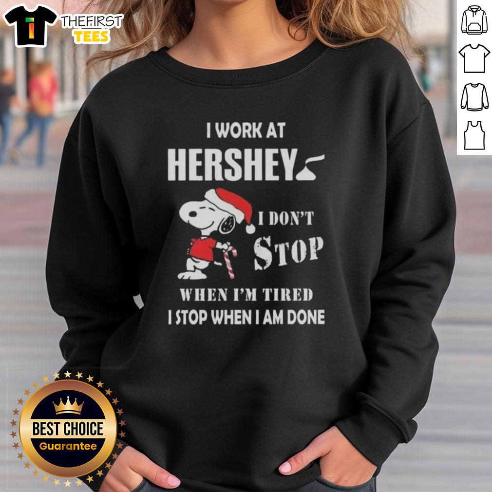top-snoopy-i-work-at-hershey-i-dont-stop-when-im-tired-i-stop-when-i-am-done-christmas-sweatshirt Cozy Christmas sweatshirt featuring Snoopy with 'I Work At Hershey, I Dont Stop When Im Tired' slogan.