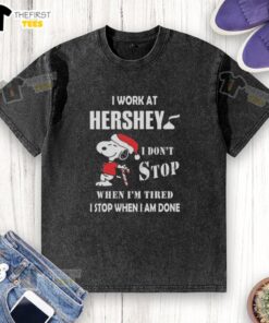 Alt Text: Top Snoopy t-shirt featuring 'I work at Hershey, I dont stop when Im tired, I stop when Im done' design for Christmas.