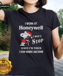 Alt Text: Snoopy graphic t-shirt for women: 'I work at Honeywell, I don't stop when I'm tired, I stop when I'm done' Christmas design.