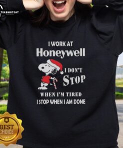 Snoopy Christmas sweatshirt featuring 'I work at Honeywell, I don't stop when I'm tired, I stop when I'm done' design.