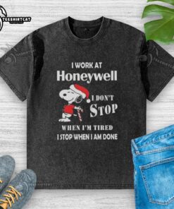 Top Snoopy I Work At Honeywell Christmas T-Shirt showcasing determination and work ethic in a fun design.