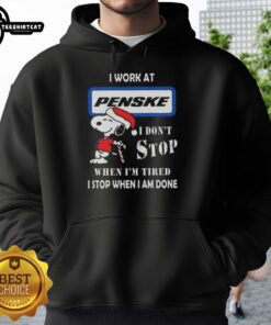 Top Snoopy hoodie for Christmas featuring the quote: 'I work at Penske Corporation, I don't stop when I'm tired, I stop when I'm done.'