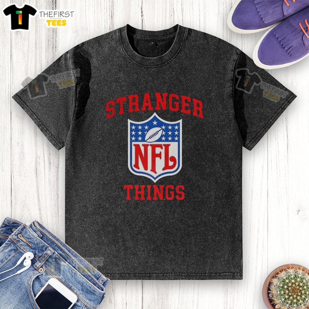 top-stranger-things-x-nfl-logo-washed-t-shirt Alt Text: Top Stranger Things X NFL logo washed t-shirt featuring a vintage design and soft fabric, perfect for fans.