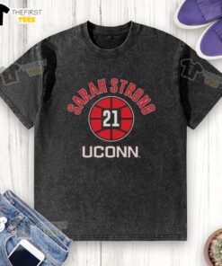 Alt Text: Top UConn Huskies basketball Sarah Strong name number 21 washed t-shirt in navy blue, perfect for fans.