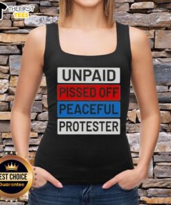 Unpaid peaceful protester wearing a tank top with 'Top Unpaid Pissed Off' slogan at a rally, showcasing activism.