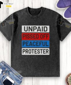 Top unpaid peaceful protester wearing a washed t-shirt, expressing frustration during a demonstration for social change.