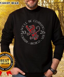 Top Well Be Coming Scotland sweatshirt featuring the Scottish World Cup 2026 logo for Canada, Mexico, and USA.