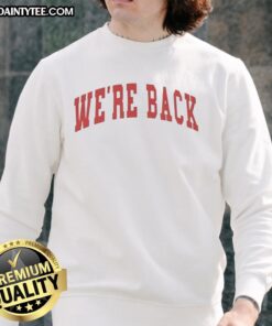 Alt Text: Red letter sweatshirt with 'We're Back' printed on the front, perfect for casual wear and trendy outfits.