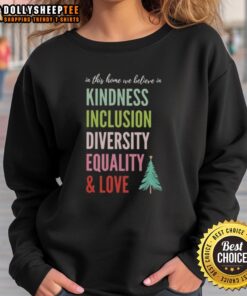 Christmas tree sweatshirt featuring the message 'In this home, we believe in kindness, inclusion, diversity, equality, and love'.