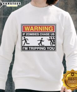 Original Warning: If Zombies Chase Us, I'm Tripping You Sweatshirt featuring a humorous zombie graphic design.