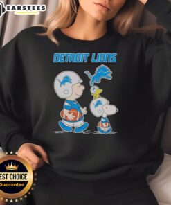 Alt Text: Awesome Detroit Lions X Snoopy and Charlie Brown sweatshirt featuring vibrant graphics and team colors.