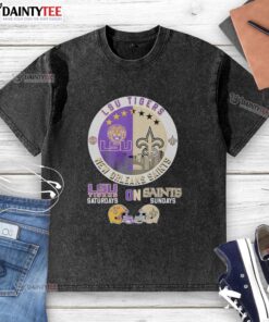 Alt Text: LSU Tigers and New Orleans Saints helmet logo mashup on a washed t-shirt, perfect for game day attire.