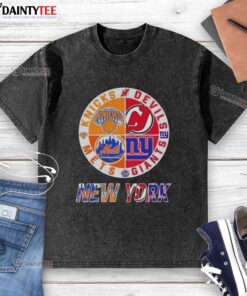 Alt Text: Awesome New York City sports logos on a washed t-shirt featuring Knicks, Devils, Giants, and Mets designs.