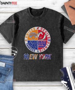 Awesome New York City sports t-shirt featuring Knicks, Devils, Giants, and Yankees logos in a stylish, washed design.
