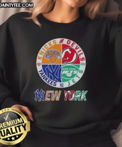 Alt Text: Awesome New York City sports sweatshirt featuring Knicks, Devils, Jets, and Yankees logos for fans.