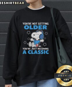 Awesome Snoopy sweatshirt with 'You're Not Getting Older, You're Just Becoming a Classic' design for nostalgic fans.