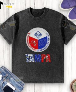 Alt Text: Awesome Tampa Bay city sports logos on a washed t-shirt featuring Rays, Lightning, and Buccaneers designs.