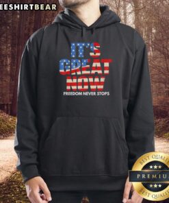 Patriotic hoodie featuring the USA flag with 'Freedom Never Stops' text, perfect for celebrating American pride.