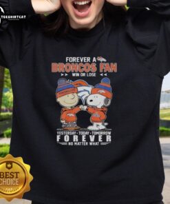 Alt Text: Cute Charlie Brown fist bump with Snoopy, celebrating Denver Broncos fandom in a cozy sweatshirt, win or lose.