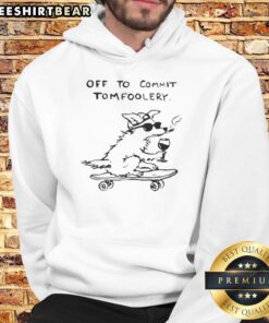Cute dog wearing a hoodie labeled 'Off to Commit Tomfoolery' in a playful pose outdoors.