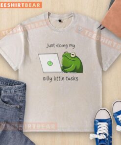 Cute frog wearing a washed t-shirt, happily completing its silly little tasks in a vibrant green environment.