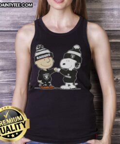 Adorable Charlie Brown and Snoopy fist bump in a Las Vegas Raiders football tank top, perfect for fans and collectors.