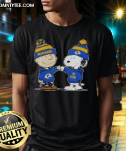 Alt Text: Cute Peanuts Charlie Brown and Snoopy fist bump on Los Angeles Rams football t-shirt, perfect for fans.
