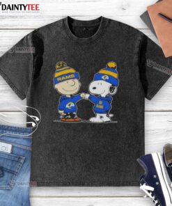 Charlie Brown and Snoopy fist bump in a cute Peanuts design on a Los Angeles Rams football washed t-shirt.
