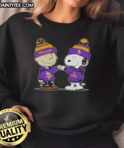 Cute Peanuts Charlie Brown and Snoopy fist bump in Minnesota Vikings football sweatshirt, perfect for fans.