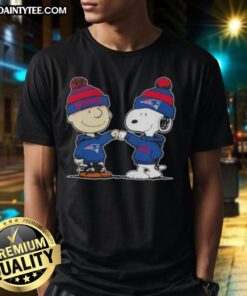 Charlie Brown and Snoopy fist bump on New England Patriots football T-Shirt, perfect for fans and Peanuts lovers.