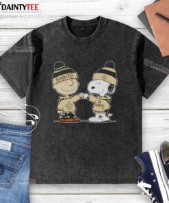 Alt Text: Cute Peanuts Charlie Brown and Snoopy fist bump in New Orleans Saints football washed t-shirt design.