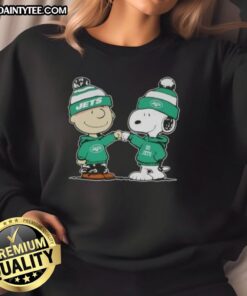 Charlie Brown and Snoopy fist bump in a Cute Peanuts sweatshirt featuring New York Jets football design.