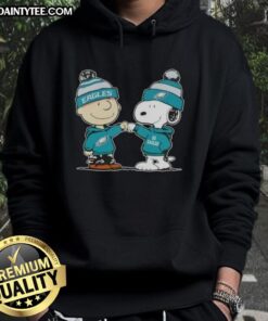 Alt Text: Cute Peanuts Charlie Brown fist bumping Snoopy in a Philadelphia Eagles football hoodie, perfect for fans.