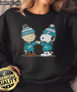 Alt Text: Cute Peanuts Charlie Brown and Snoopy fist bump on Philadelphia Eagles football sweatshirt design.