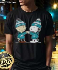 Alt Text: Cute Peanuts Charlie Brown and Snoopy fist bump on Philadelphia Eagles football T-shirt design.